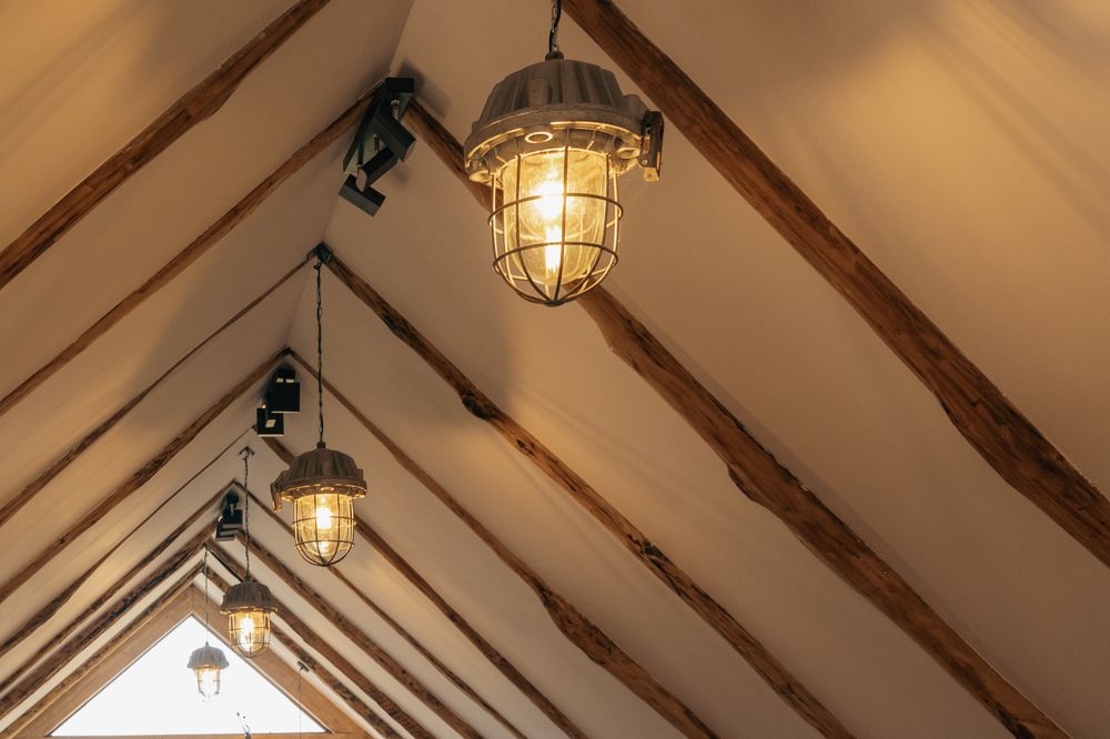 An attic lounge at Debatoun with timber beams and a green valley view