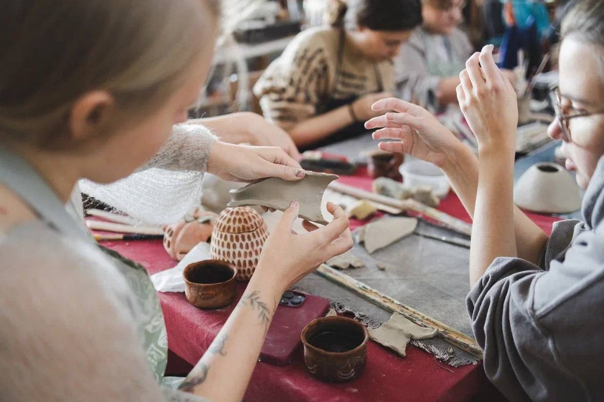A pottery workshop in progress, hands working with clay