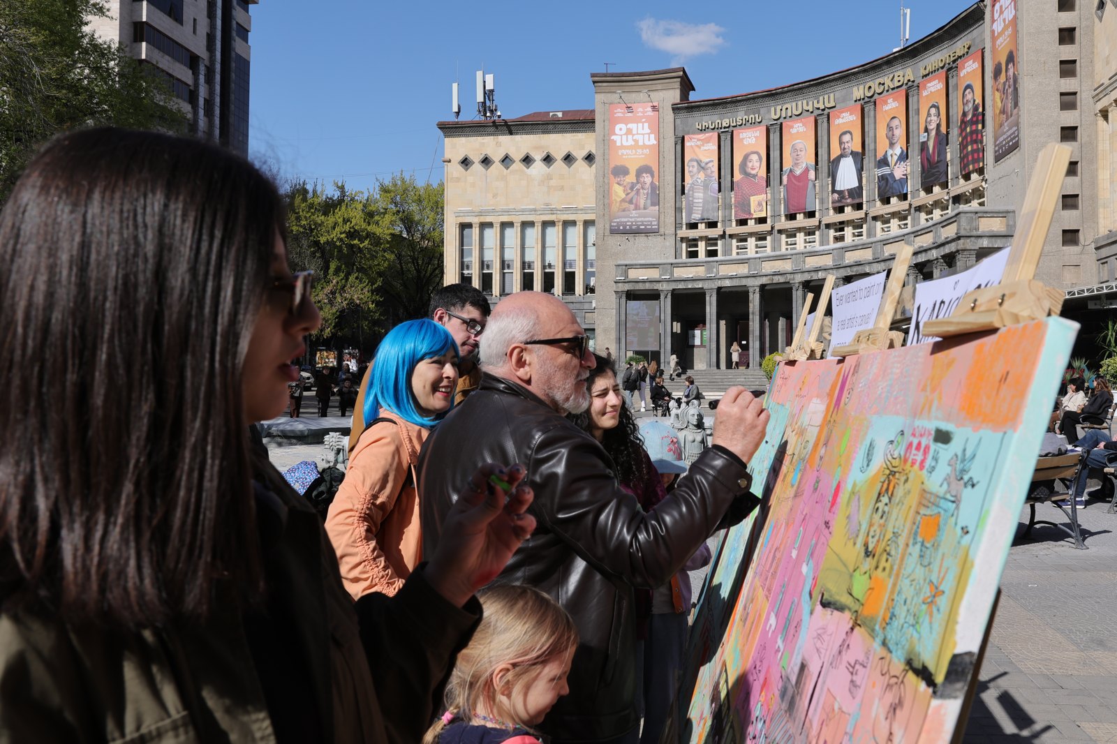 Residents of Yerevan painting on the canvas in the city square