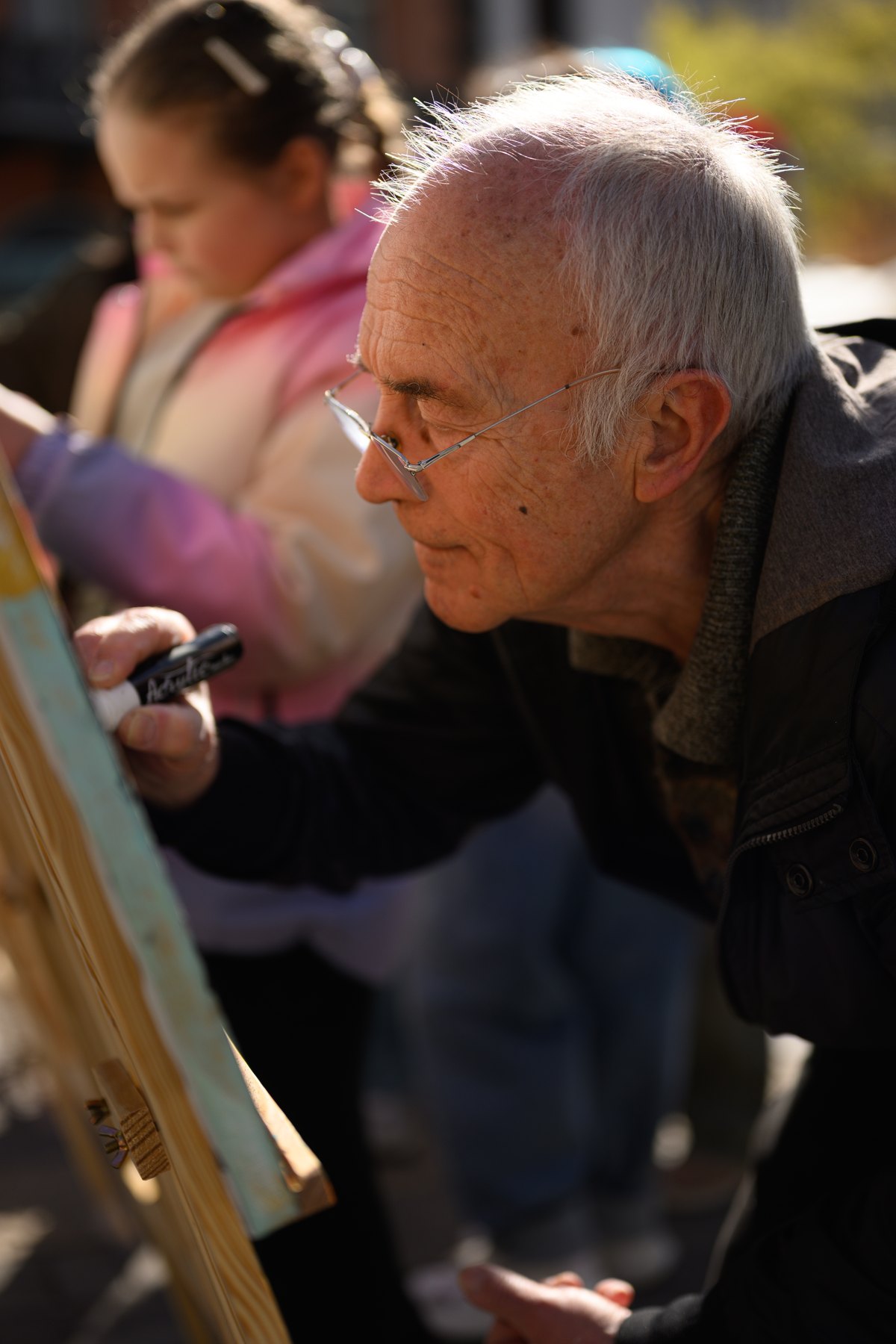 The artist inviting passers-by to contribute
