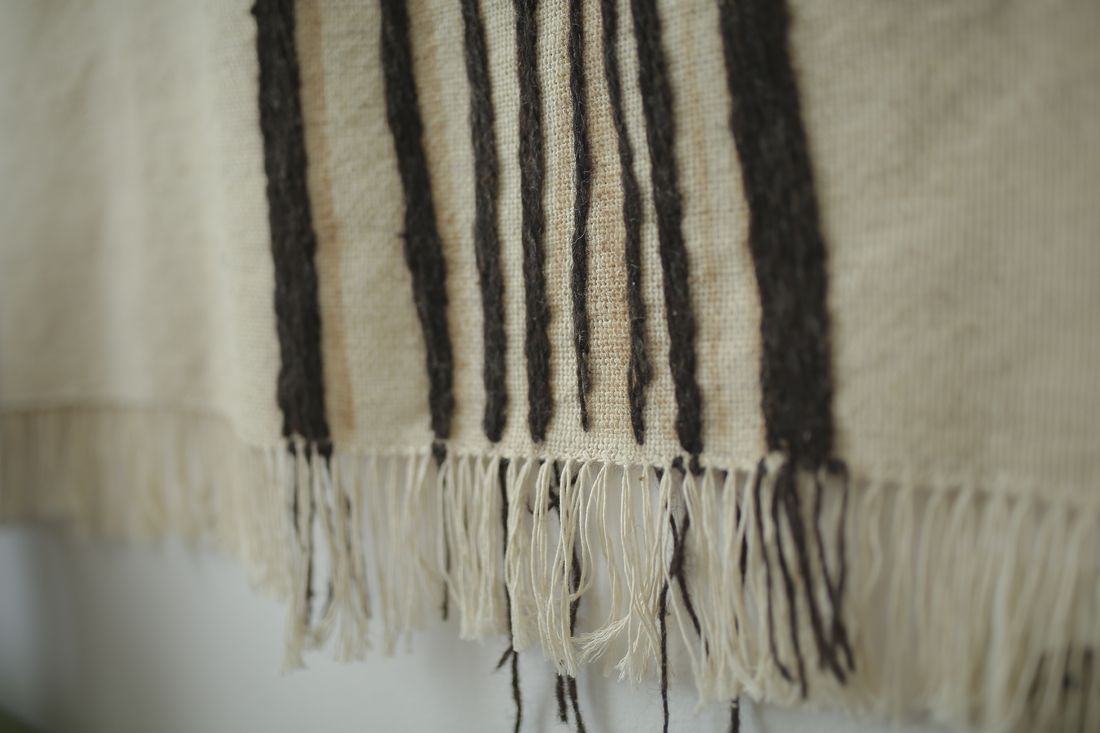 Close detail of the woven wool and fringed edge of the Prelude blanket