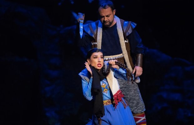 Two singers in costume during an opera production at the theatre